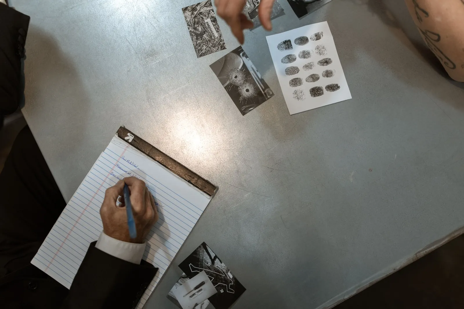 Hands cutting and arranging printed photographs
