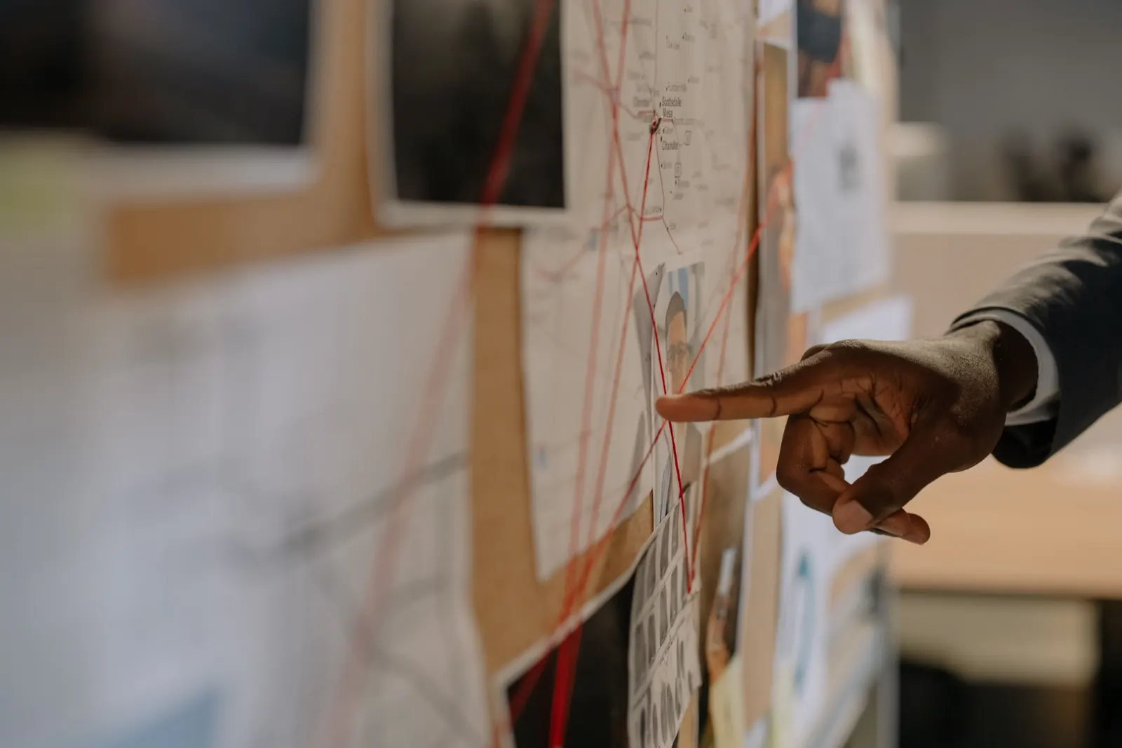 Investigation board with photos and red string
