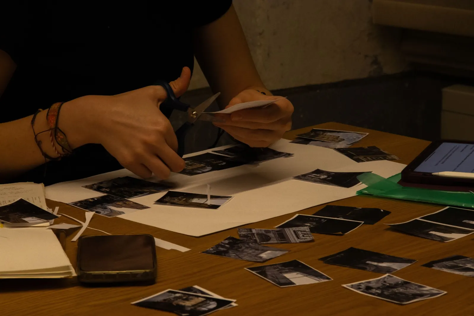 Creative work with photographs and prints on a desk